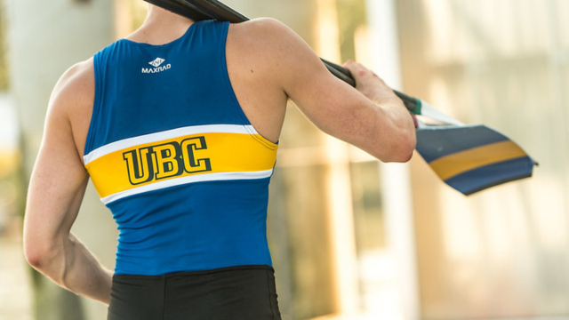 UBC varsity rower holding an oar